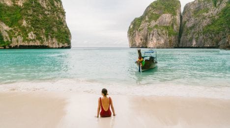 my-thailand-woman-laying-on-a-beach-in-krabi-with-a-boat-nearby